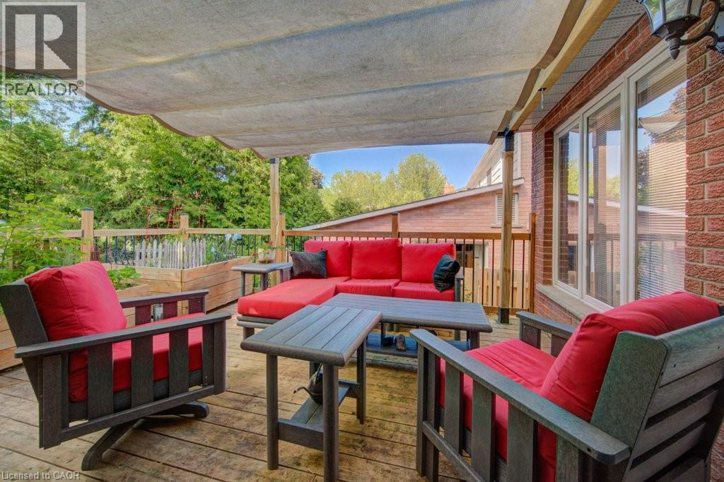 Spacious wood-finish deck with a fabric shade canopy - 60 Mayfield Avenue, Waterloo, ON