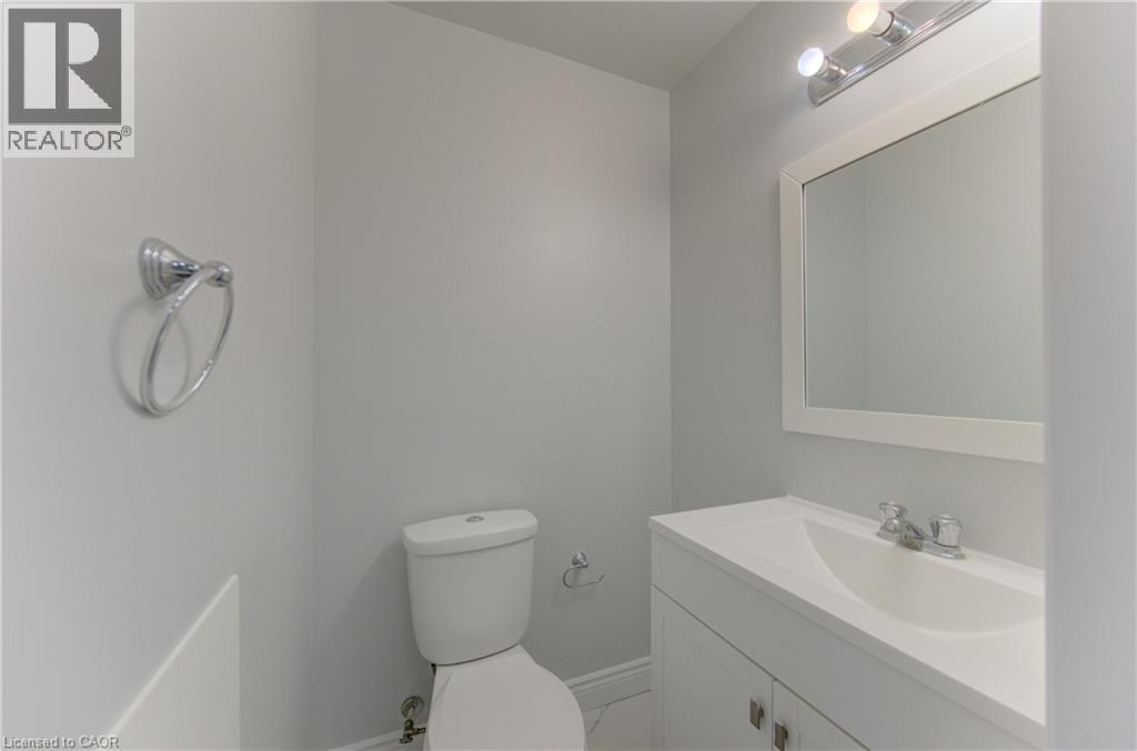 White vanity with an integrated sink and chrome fixtures - 80 Lower Canada Crescent, Kitchener, ON
