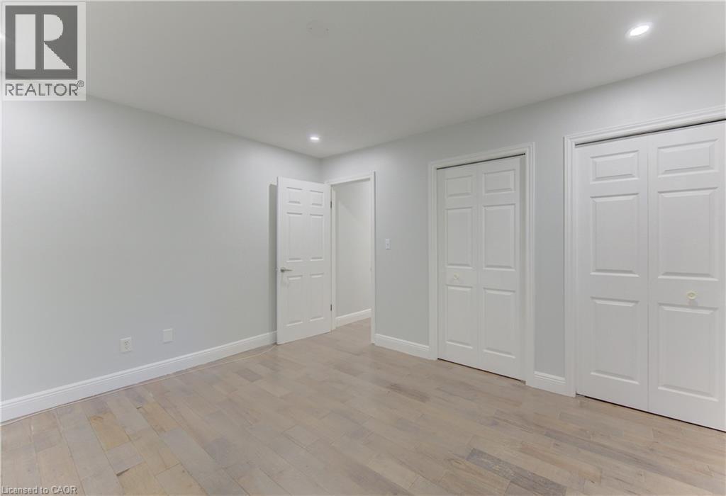 Light-toned wood-finish flooring complements the neutral wall color and white trim - 80 Lower Canada Crescent, Kitchener, ON