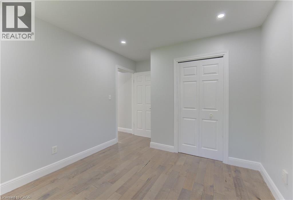 Interior room featuring wood-finish flooring, recessed lighting, and a bi-fold closet door - 80 Lower Canada Crescent, Kitchener, ON