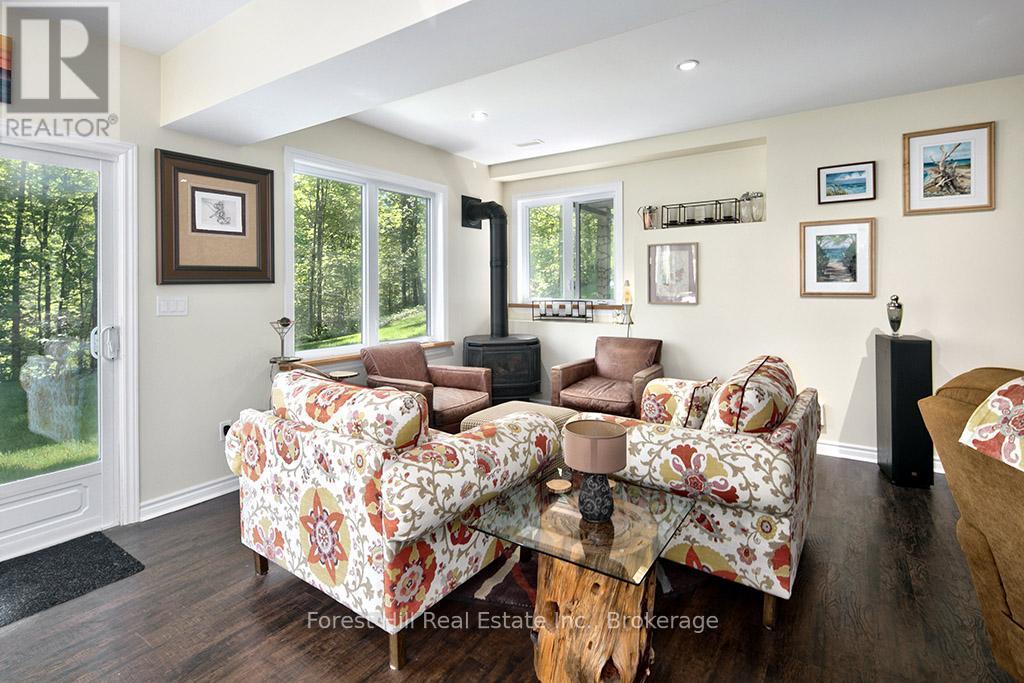 Lower level with lots of natural light & fireplace - 157 Glen Fiddish Road, West Grey, ON - Indoor Photo Showing Other Room