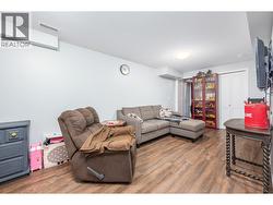 Recreation area in basement with access to storage area and outside door. -