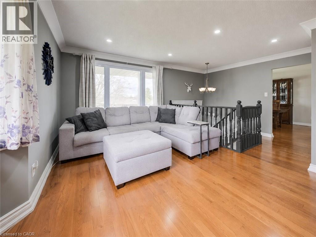 Kitchen featuring white upper cabinetry, light gray lower cabinetry, and light countertops - 4 Ronald Road, Cambridge, ON
