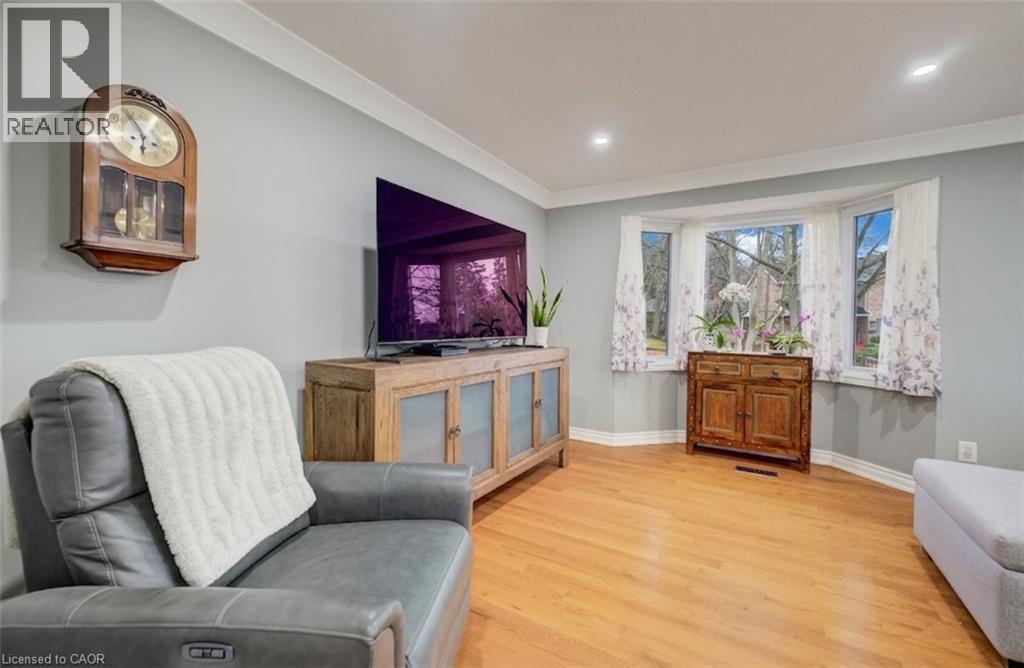 Kitchen featuring two-tone cabinetry, subway tile backsplash, stainless steel appliances, and a window above the sink - 4 Ronald Road, Cambridge, ON