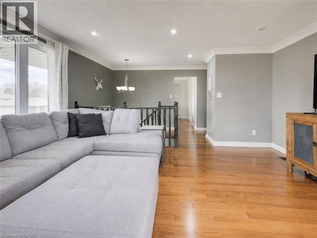 Modern kitchen featuring white upper cabinetry, light gray lower cabinetry, stainless steel appliances, a white subway tile backsplash, and light tile flooring - 4 Ronald Road, Cambridge, ON