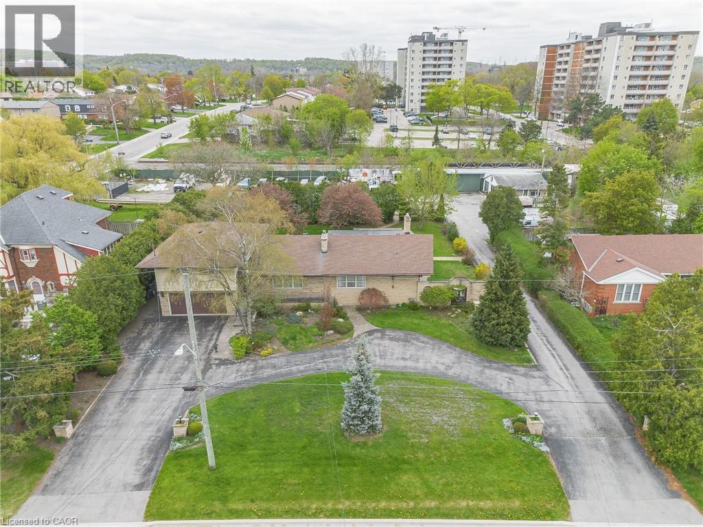 Spacious property featuring an expansive lawn, a split driveway for vehicle access, and a two-car garage - 262-270-276 Hixon Road, Hamilton, ON