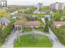 Spacious property featuring an expansive lawn, a split driveway for vehicle access, and a two-car garage -