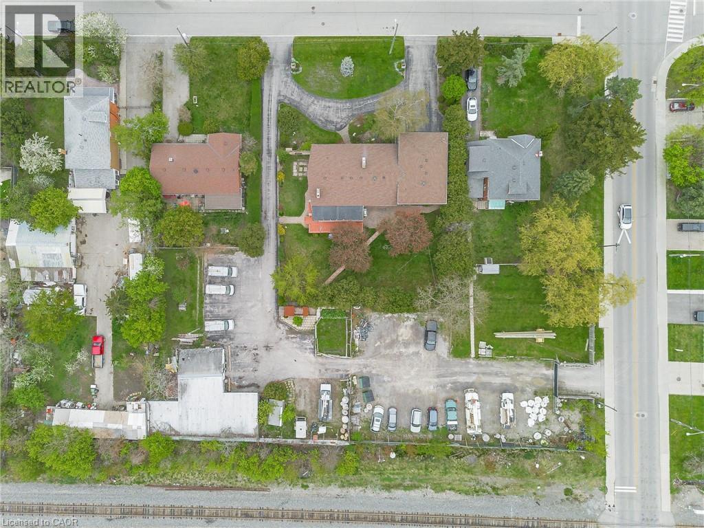 Extensive property featuring multiple structures, paved parking areas, and mature trees - 262-270-276 Hixon Road, Hamilton, ON