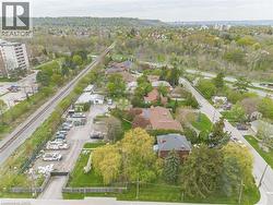 Aerial perspective showcasing a residential area with varied housing styles, mature trees, and a railway line -