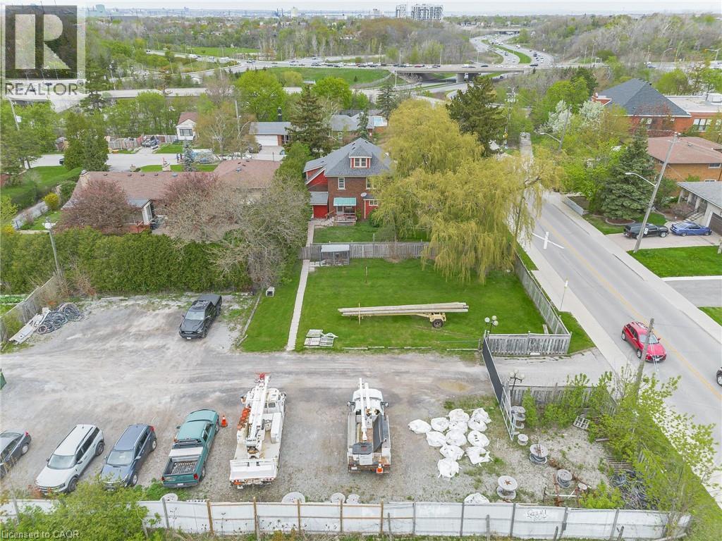 Aerial perspective showcasing a residential property with a red-sided structure, a front lawn, and surrounding mature trees - 262-270-276 Hixon Road, Hamilton, ON