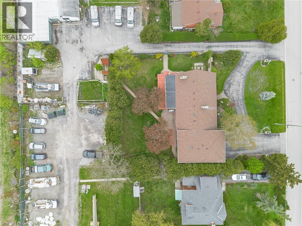 Aerial view of the property featuring a brown shingle roof, paved driveway, and established trees - 262-270-276 Hixon Road, Hamilton, ON