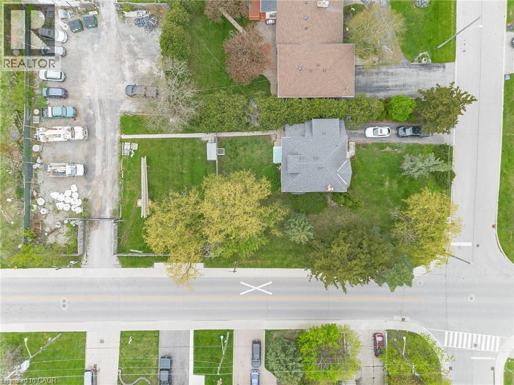 Single-story home featuring a gray shingle roof and surrounding green space - 262-270-276 Hixon Road, Hamilton, ON