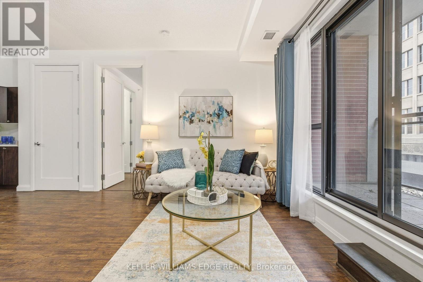 Bright open-concept living area with balcony - 408 - 112 King Street E, Hamilton, ON
