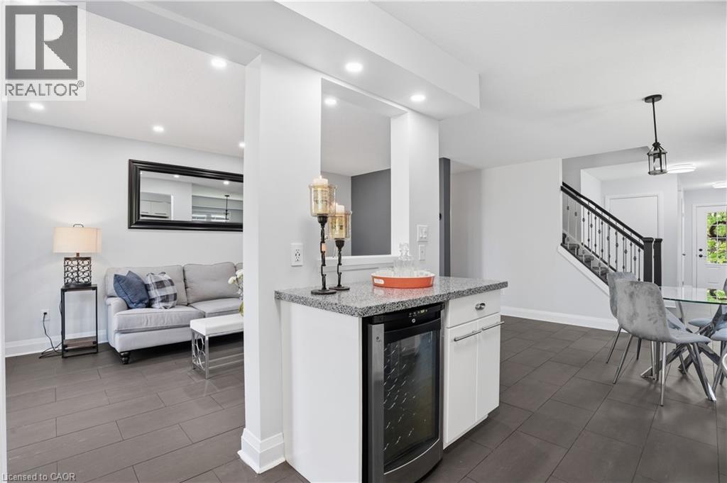 Kitchenette featuring a built-in beverage cooler, light-toned countertop, and white cabinetry - 7 Upper Mercer Street Unit# G30, Kitchener, ON - Indoor