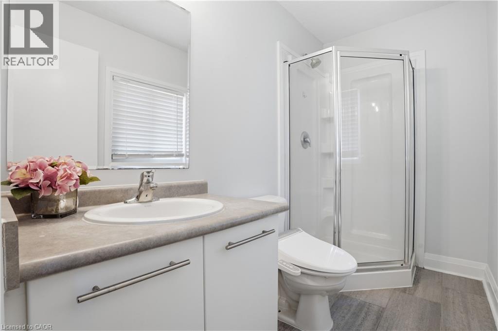 Bathroom featuring a vanity with a white basin sink, polished chrome faucet, and gray countertop - 7 Upper Mercer Street Unit# G30, Kitchener, ON - Indoor Photo Showing Bathroom