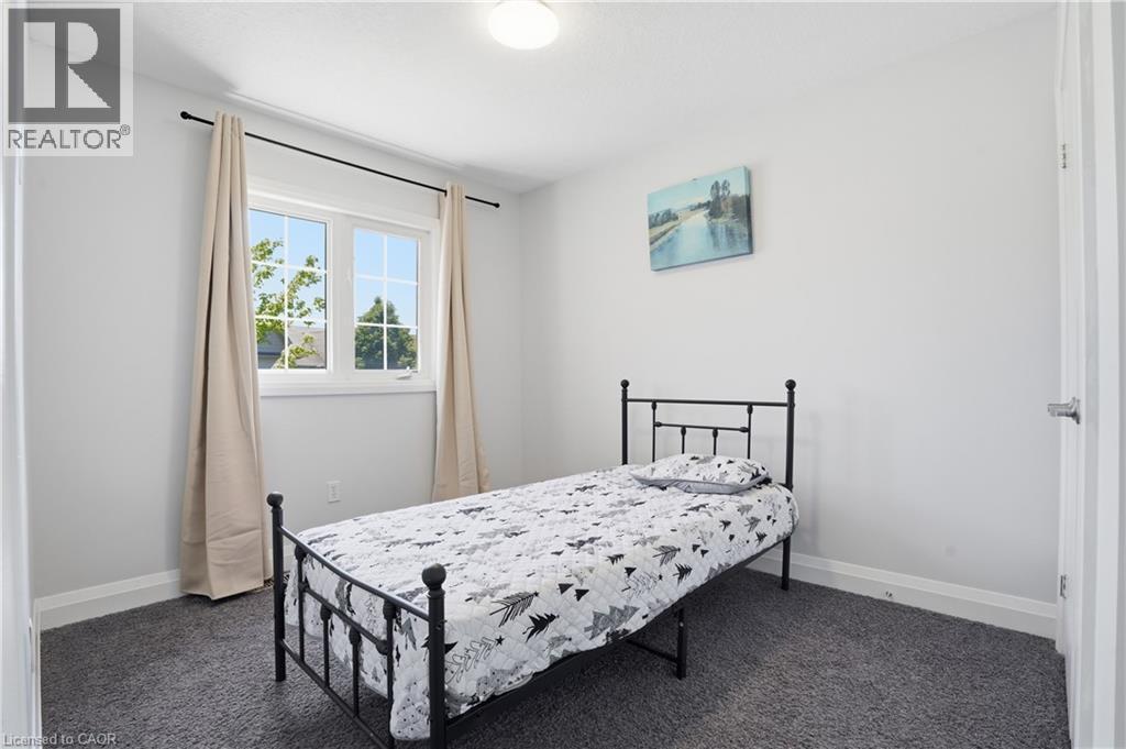 Second bedroom with Neutral wall tones enhance this room with soft gray carpeting - 7 Upper Mercer Street Unit# G30, Kitchener, ON - Indoor Photo Showing Bedroom