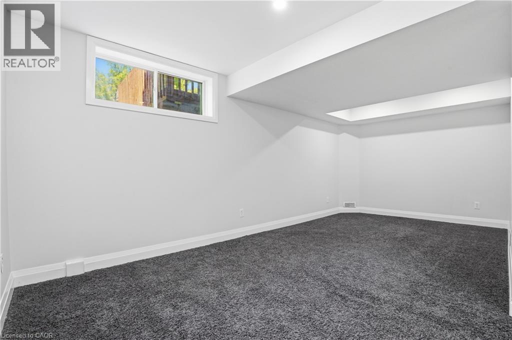 Spacious room featuring neutral paint, gray carpeting, a single window, white trim, and recessed ceiling lighting - 7 Upper Mercer Street Unit# G30, Kitchener, ON - Indoor Photo Showing Other Room