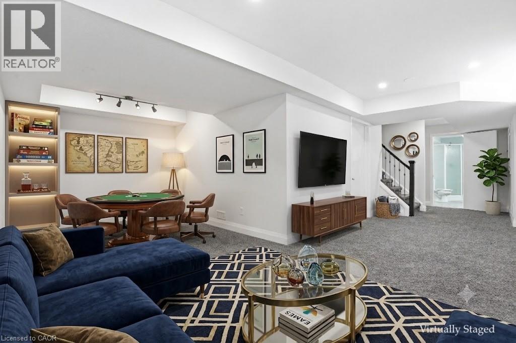 Virtually staged Spacious lower-level area featuring gray - 7 Upper Mercer Street Unit# G30, Kitchener, ON - Indoor Photo Showing Living Room