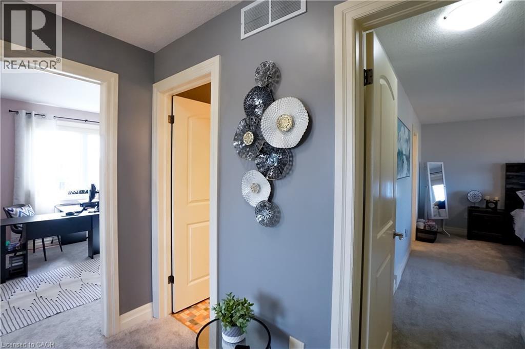 Hallway featuring light gray walls, white trim, and light gray carpet - 365 Poldon Drive, Norwich, ON