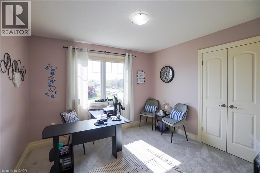 Bright room with neutral carpet flooring and a large double-pane window - 365 Poldon Drive, Norwich, ON