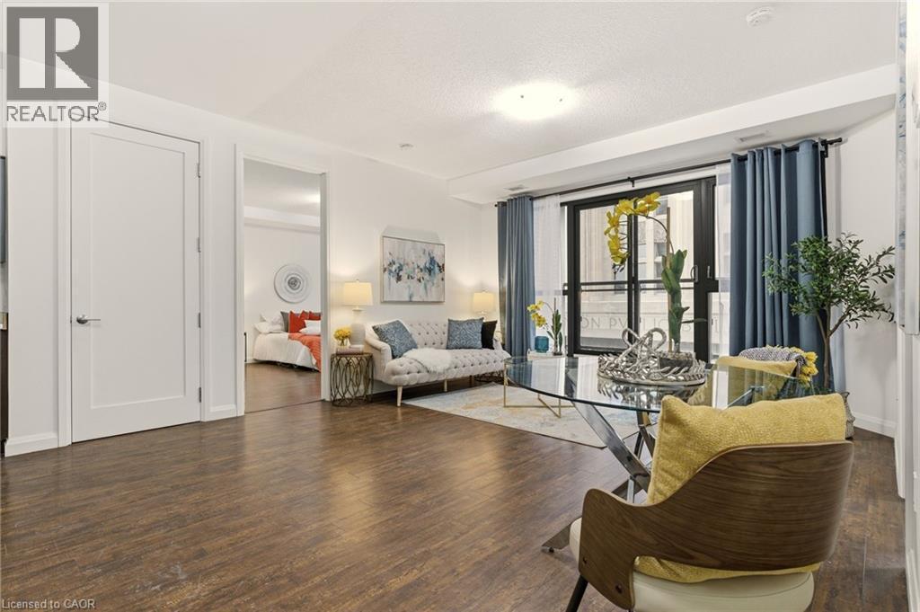 Bright open-concept living area with balcony - 112 King Street E Unit# 408, Hamilton, ON