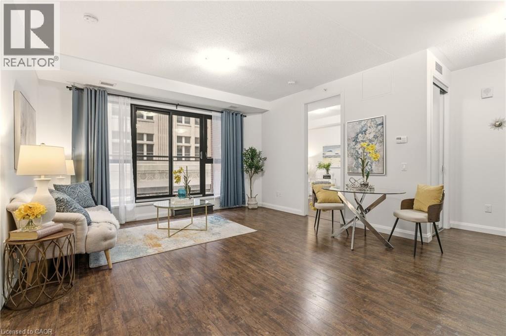 Bright open-concept living area with balcony - 112 King Street E Unit# 408, Hamilton, ON