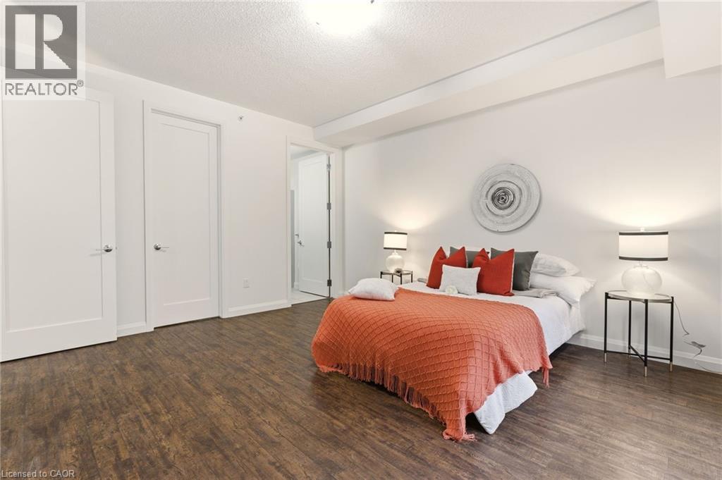 Spacious primary bedroom with large windows, 4PC Ensuite & Closet - 112 King Street E Unit# 408, Hamilton, ON