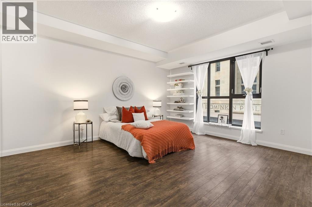 Spacious primary bedroom with large windows, 4PC Ensuite & Closet - 112 King Street E Unit# 408, Hamilton, ON