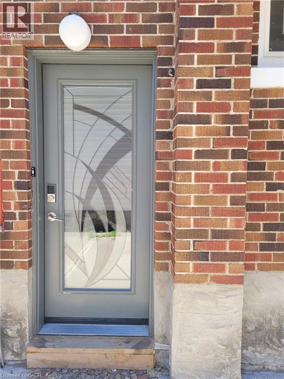 Entry door with decorative glass insert and smart lock - 153 Arnold Street, Kitchener, ON