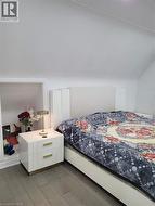 Wood-finish flooring with a sloped ceiling and recessed nook -