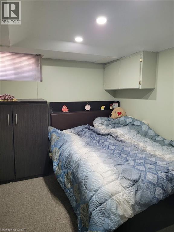 Room featuring recessed lighting, a built-in wall cabinet, and a window with blinds - 153 Arnold Street, Kitchener, ON