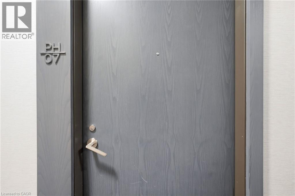Entry door with a wood-grain finish and modern hardware - 7 Mabelle Avenue Unit# Ph07, Toronto, ON