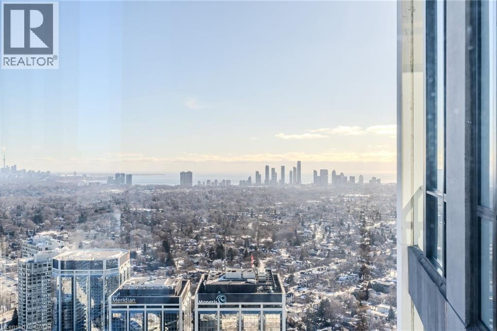 Expansive cityscape from a high-rise window, featuring a distant skyline and a wide expanse of urban landscape - 7 Mabelle Avenue Unit# Ph07, Toronto, ON