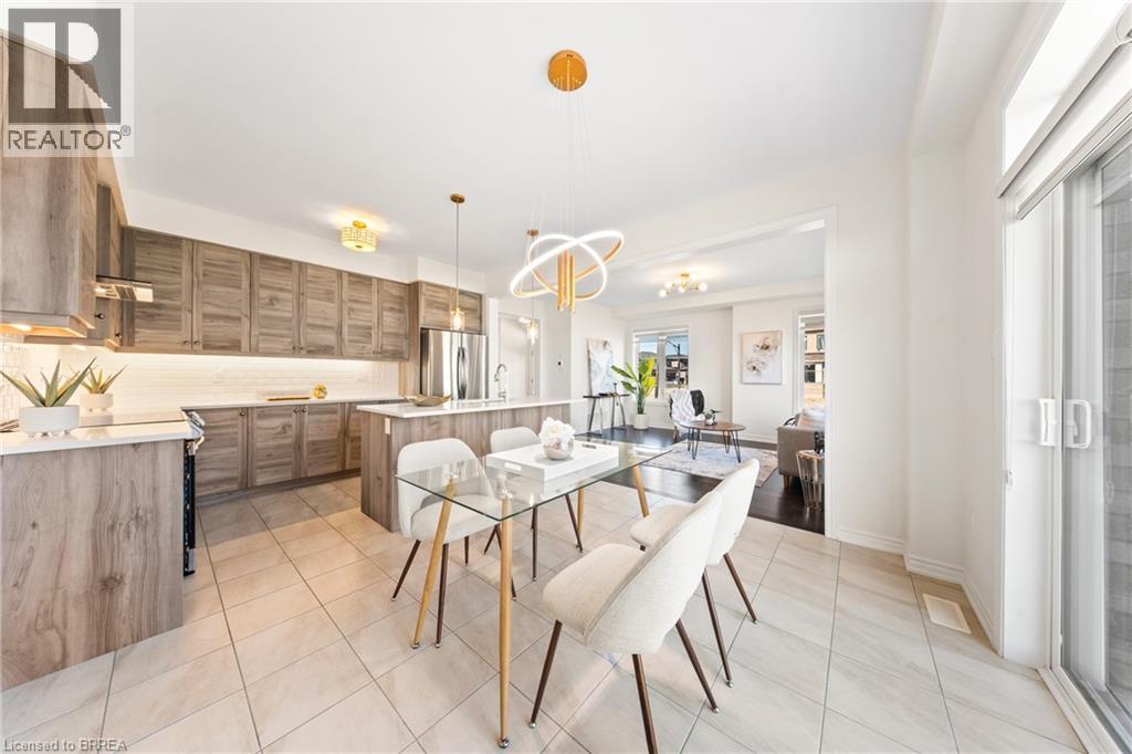 Dining room featuring light tile patterned flooring and a chandelier - 1 Bee Crescent, Brantford, ON