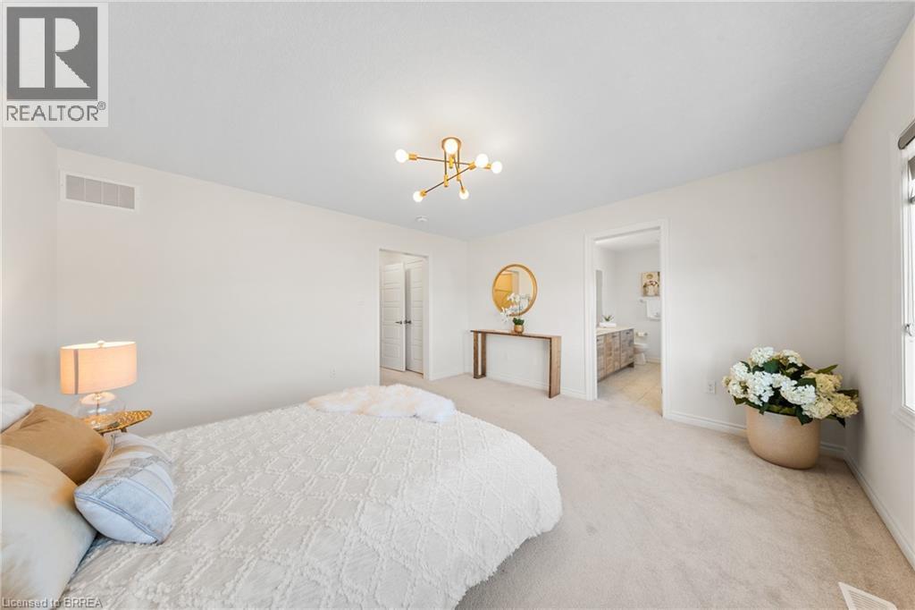 Carpeted bedroom featuring a chandelier and baseboards - 1 Bee Crescent, Brantford, ON