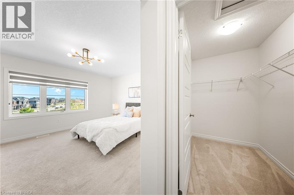 Bedroom featuring light carpet, a textured ceiling, and a chandelier - 1 Bee Crescent, Brantford, ON