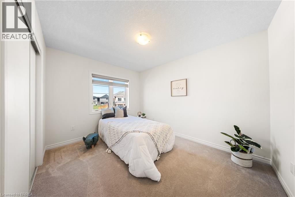 Carpeted bedroom with baseboards and a textured ceiling - 1 Bee Crescent, Brantford, ON