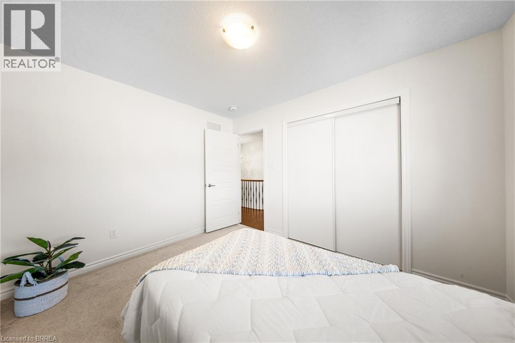 Carpeted bedroom featuring baseboards and a closet - 1 Bee Crescent, Brantford, ON