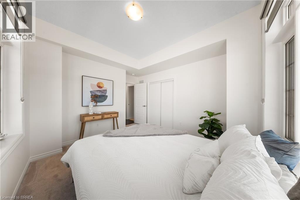 Carpeted bedroom featuring a closet and baseboards - 1 Bee Crescent, Brantford, ON