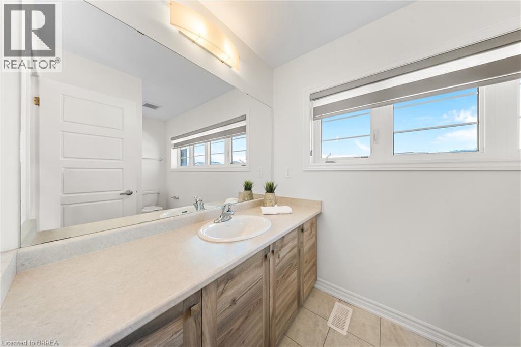 Bathroom featuring vanity and light tile patterned floors - 1 Bee Crescent, Brantford, ON