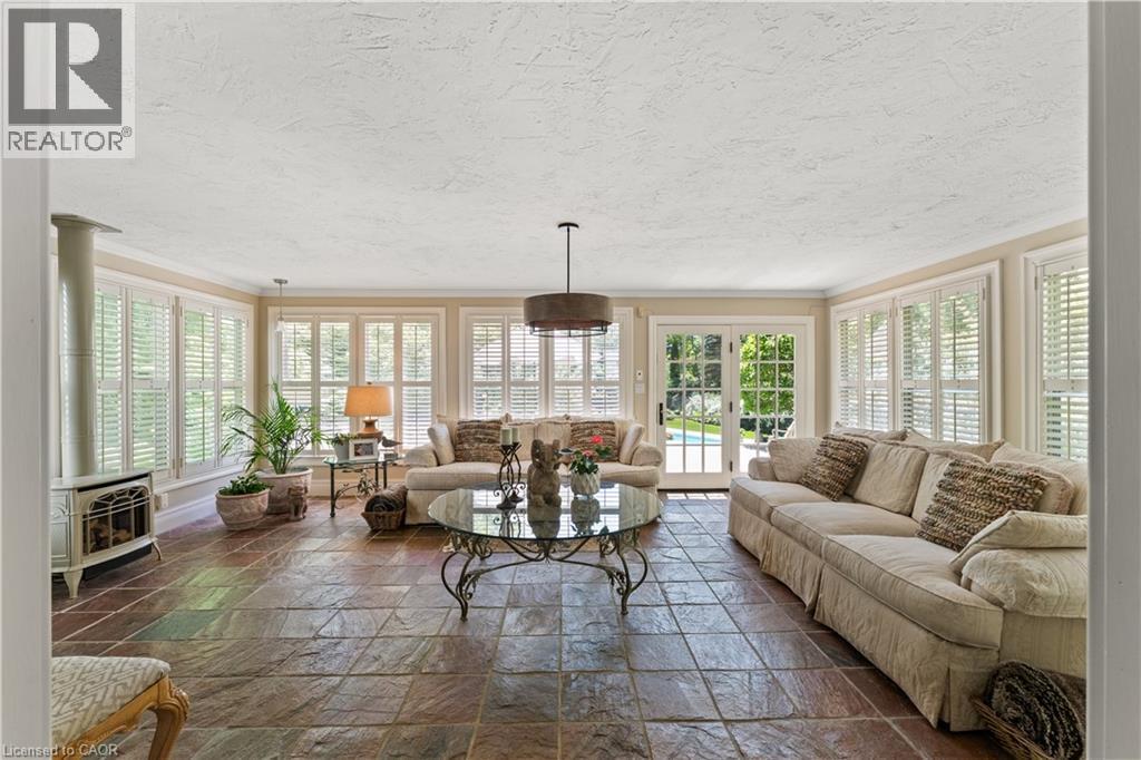 Copper slate flooring. Heated floor. Vermont stove. Updated fixture. French doors to deck are 'true-divided lights'. - 3040 First Street, Burlington, ON - Outdoor