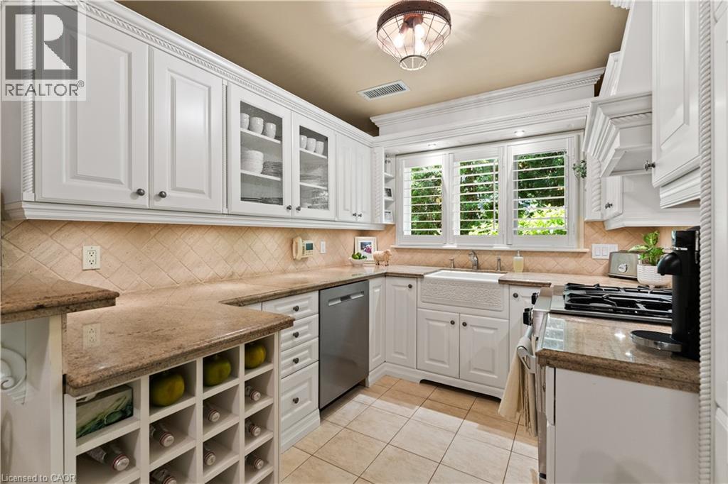 Maytag fridge and dishwasher. Wine rack. Heated floor. Jenn-aire dual fuel gas/electric range. Granite counter. Plantation shutters. Kohler sink. - 3040 First Street, Burlington, ON - Indoor Photo Showing Other Room