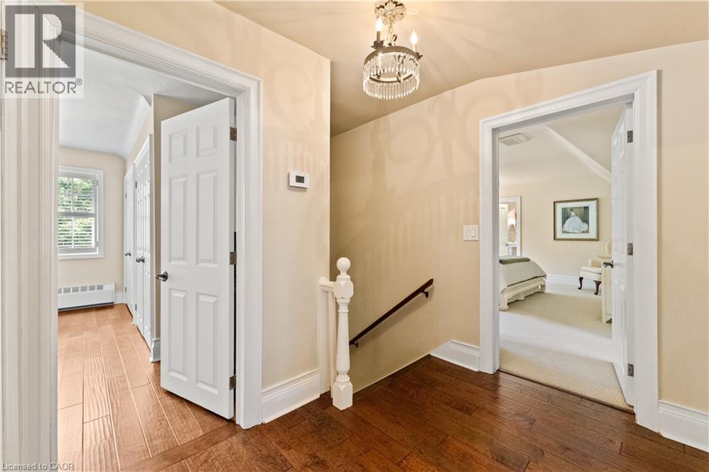 Upper hallway. 3 bedrooms, 2 bathrooms. Generously sized linen closet with light. Antique French light fixture. - 3040 First Street, Burlington, ON - Indoor Photo Showing Other Room