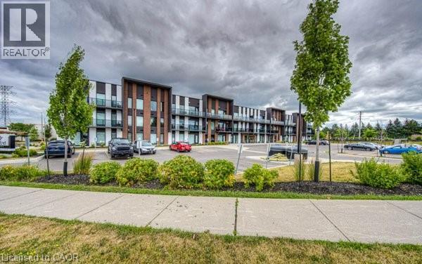 Contemporary building with dark and light paneling and brick accents - 5 Wake Robin Drive Unit# 107, Kitchener, ON