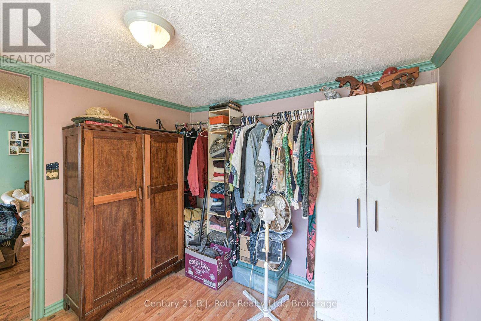 Primary bedroom closet (AI enhanced) - 3427 Coronation Avenue, Severn (West Shore), ON