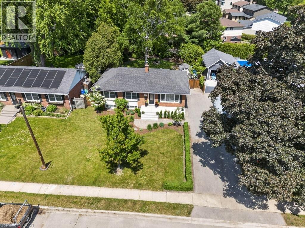 Brick bungalow featuring a charcoal shingle roof and white-trimmed windows - 603 Cornick Drive, Burlington, ON