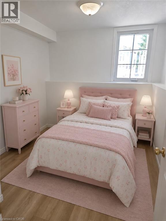 Room featuring a single-paned window, wood-finish flooring, a white ceiling with a flush-mount light fixture, and white painted walls - 390 Wake Robin Crescent, Kitchener, ON - Indoor Photo Showing Bedroom