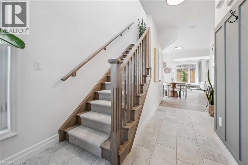 Hardwood staircase with carpeted treads and wood balusters - 30 Waterbow Trail, Kitchener, ON - Indoor Photo Showing Other Room
