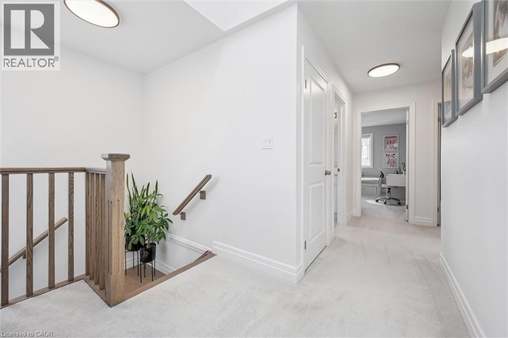 Upper-level hallway featuring light carpeting, white walls, and recessed lighting - 30 Waterbow Trail, Kitchener, ON - Indoor Photo Showing Other Room