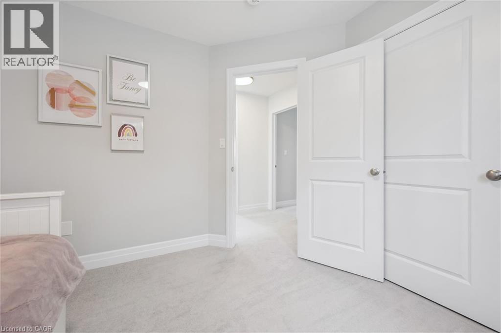 Interior room featuring light grey wall paint and light grey carpet flooring - 30 Waterbow Trail, Kitchener, ON - Indoor